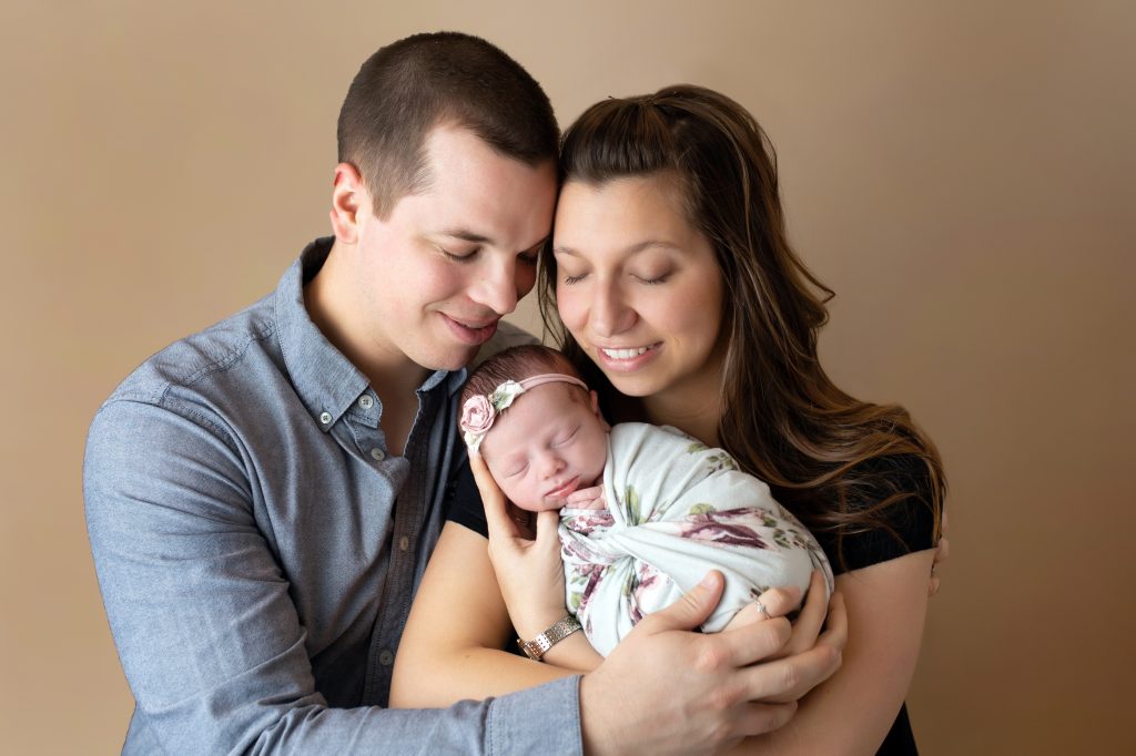 First family photo of Mom, dad and newborn baby girl.